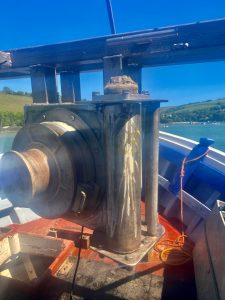 Vertical mounted gunnel roller on a commercial fishing vessel